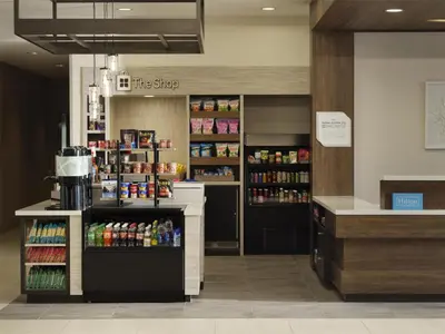 a coffee shop with a counter and some drinks at Hilton Garden Inn Merced in Merced