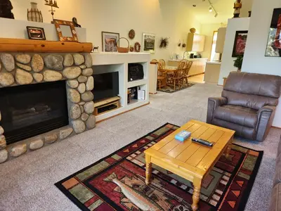 a living room with a fireplace and a table at Snowcreek Resort Vacation Rental 934 in Mammoth Lakes