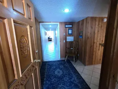 a hallway of a house with a door and a chair at Rr-interlaken 09 in June Lake
