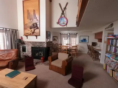 a living room with a fireplace and a dining room at Rr-interlaken 09 in June Lake