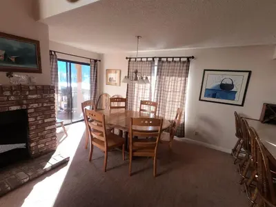 a dining room with a table and chairs and a fireplace at Rr-interlaken 09 in June Lake