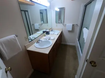 a bathroom with two sinks and a large mirror at Rr-interlaken 09 in June Lake