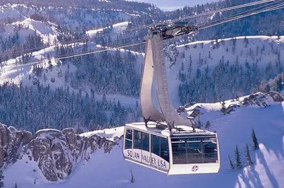 a gondola flying over a snow covered mountain at Everline Resort & Spa 630 in Olympic Valley