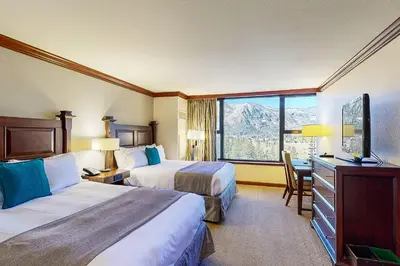 a hotel room with two beds and a window at Everline Resort & Spa 806 in Olympic Valley