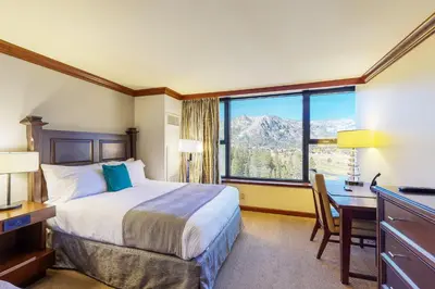 a hotel room with a bed and a desk and a window at Everline Resort & Spa 806 in Olympic Valley