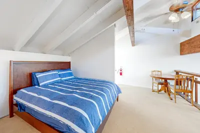 a bedroom with a bed and a table in a room at Moose Roost in Incline Village