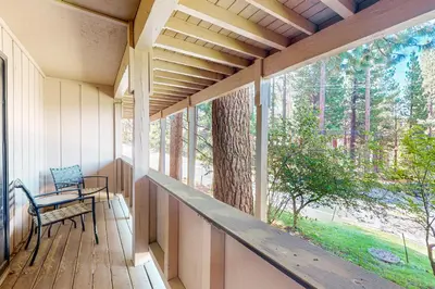 a porch with a bench and a large window at Moose Roost in Incline Village