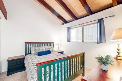 a bedroom with a bed and a window at Moose Roost in Incline Village