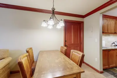 a dining room with a wooden table and chairs at Everline Resort & Spa 607B in Olympic Valley