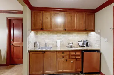 a kitchen with wooden cabinets and a sink at Everline Resort & Spa 607B in Olympic Valley