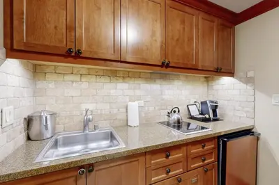 a kitchen with wooden cabinets and a sink at Everline Resort & Spa 607B in Olympic Valley