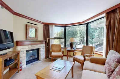 a living room with a fireplace and a tv at Everline Resort & Spa 607B in Olympic Valley