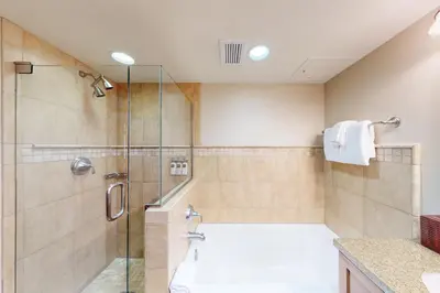 a bathroom with a shower and a bath tub at Everline Resort & Spa 810 in Olympic Valley