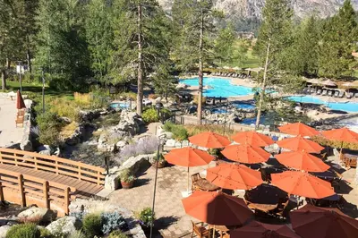 a resort with orange umbrellas and a swimming pool at Everline Resort & Spa 810 in Olympic Valley