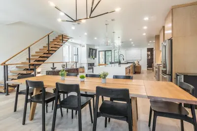 a dining room and kitchen with a large wooden table and chairs at The Reserve #126 in Mammoth Lakes