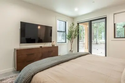 a bedroom with a large bed with a tv on the wall at The Reserve #126 in Mammoth Lakes