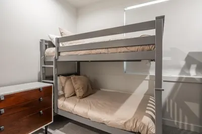 a bedroom with two bunk beds and a desk at The Reserve #126 in Mammoth Lakes