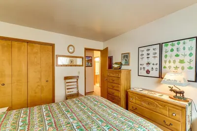 a bedroom with a bed and a dresser and a chair at Quiet Truckee Retreat with Deck, 5 Mi to Donner Lake in Truckee