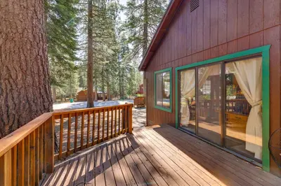 a wooden deck with a tree on the side of a house at Quiet Truckee Retreat with Deck, 5 Mi to Donner Lake in Truckee