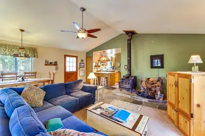 a living room with a blue couch and a table at Quiet Truckee Retreat with Deck, 5 Mi to Donner Lake in Truckee