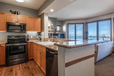 a kitchen with wooden cabinets and a counter top at Eagle Run # 204 in Mammoth Lakes