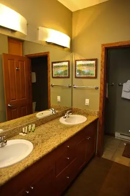 a bathroom with two sinks and a large mirror at Eagle Run # 204 in Mammoth Lakes