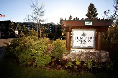 a sign in front of a building with a sign at Juniper Springs Lodge # 203 in Mammoth Lakes