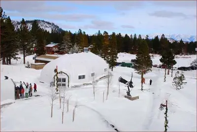 a group of people standing around a tent in the snow at Juniper Springs Lodge # 203 in Mammoth Lakes