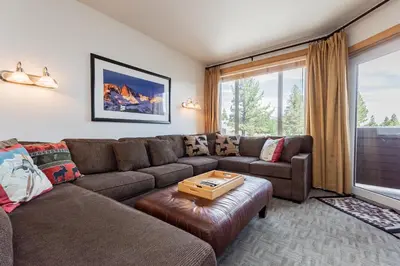 a living room with a couch and a table at Juniper Springs Lodge # 203 in Mammoth Lakes