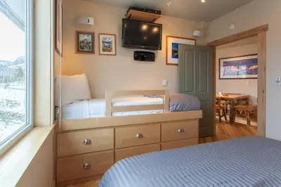 a bedroom with a bed and a tv on the wall at Juniper Springs Lodge # 426 in Mammoth Lakes