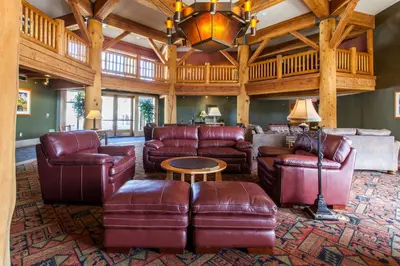 a living room with leather furniture and a wooden ceiling at Sunstone # 329 in Mammoth Lakes