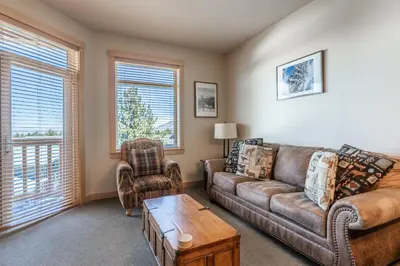 a living room with a couch and a table at Sunstone # 329 in Mammoth Lakes