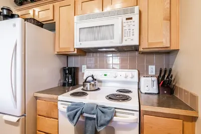 a kitchen with a white stove and a microwave at Sunstone # 329 in Mammoth Lakes