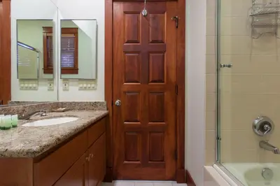 a bathroom with a sink and a shower and a door at Timbers # 1033 in Mammoth Lakes