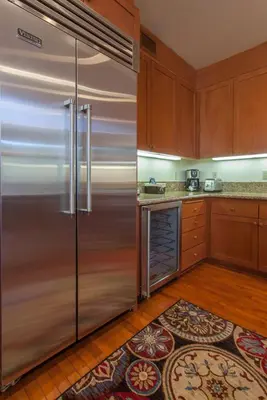 a kitchen with a large stainless steel refrigerator at Timbers # 1033 in Mammoth Lakes