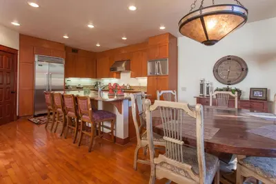 a kitchen with a wooden table and a dining room at Timbers # 1033 in Mammoth Lakes