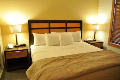 a bedroom with a large bed with two lamps at Village # 2416 - White Mountain Lodge in Mammoth Lakes