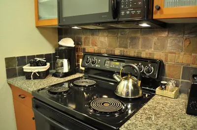 a kitchen with a stove with a tea kettle on it at Village # 2416 - White Mountain Lodge in Mammoth Lakes