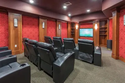 a cinema room with leather chairs and a flat screen tv at Village # 2416 - White Mountain Lodge in Mammoth Lakes