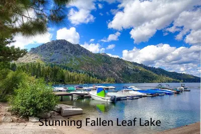 a group of boats docked at a dock on a lake at COH1444 - Fallen Leaf Relief home in South Lake Tahoe
