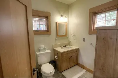 a bathroom with a toilet and a sink and a mirror at COH1444 - Fallen Leaf Relief home in South Lake Tahoe