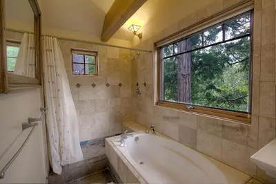 a bathroom with a bath tub and a window at COH1444 - Fallen Leaf Relief home in South Lake Tahoe