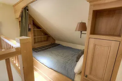 a attic room with a bed and a staircase at COH1444 - Fallen Leaf Relief home in South Lake Tahoe
