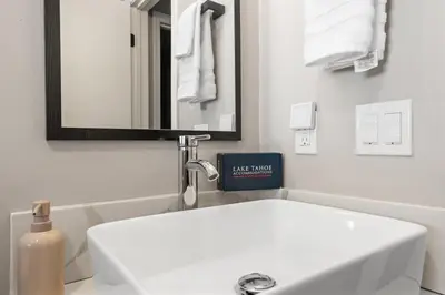 a white bathroom with a sink and a mirror at HCH0868 - The Grand Escape home in South Lake Tahoe