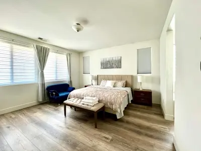 a bedroom with a bed and a blue chair at \u8212\u670d\u5bbd\u655e\u7684\u7a7a\u95f4