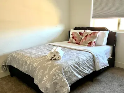 a bedroom with a bed with two stuffed animals on it at \u8212\u670d\u5bbd\u655e\u7684\u7a7a\u95f4