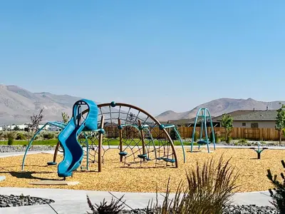a playground with a blue slide in a park at \u8212\u670d\u5bbd\u655e\u7684\u7a7a\u95f4