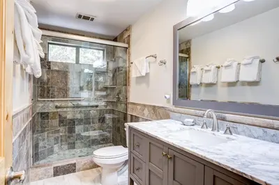 a bathroom with a shower and a toilet and a sink at 42A Megan in North Wawona