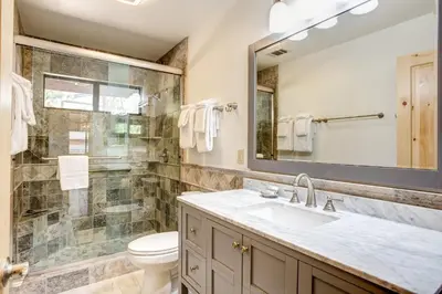 a bathroom with a sink and a toilet and a mirror at 42A Megan in North Wawona