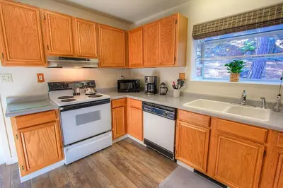 a kitchen with wooden cabinets and a sink at NVH0823 - Sadies Hustle home in Zephyr Cove